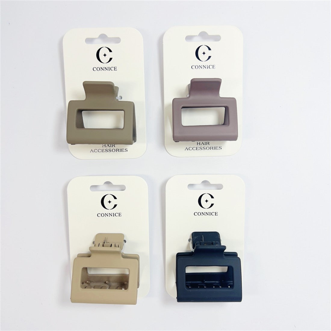 Square-shaped hair claw clip with open centre; Matte finish in neutral colours; Made from solid plastic; Mounted on white branded backing card marked CONNICE;