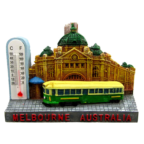 3D design showing Flinders Street Station and tram; Thermometer displaying Celsius and Fahrenheit; Bright colours with yellow, green and earthy brown tones; Text 'MELBOURNE AUSTRALIA' in red on base;