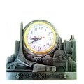 silver-tone metal frame; white clock face with black numbers; gold-coloured clock bezel; detailed Melbourne landmark cityscape; penguin figures at base;