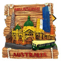 depicts Melbourne city landmarks; multicolour with green, yellow, blue accents; text 'Melbourne' and 'Australia' in red; 3D textured resin material; includes tram and buildings design;