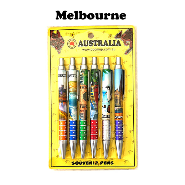 six ballpoint pens set; each pen with a unique Melbourne print; colourful, detailed city and landmark images; yellow cardboard packaging with Australian theme; click retractable metal tip;