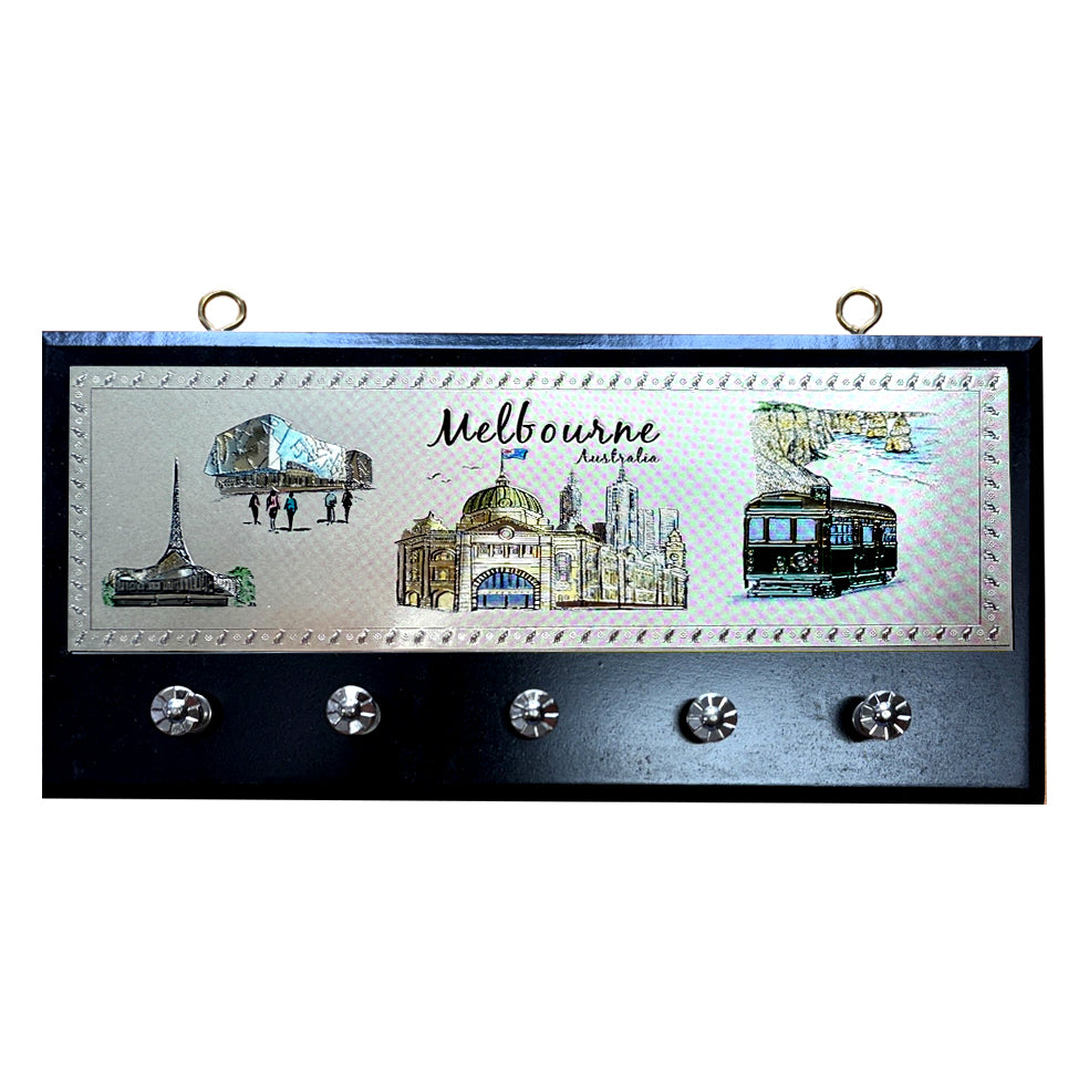 rectangular wooden base; five metal hooks; metal plaque with Melbourne landmarks; two metal wall hanging loops; dark wood colour base;