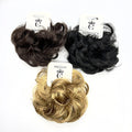 Curly synthetic hair styled as a bun; Shown in black, dark brown and blonde colours; Each piece attached to white branded hanging card; Compact, rounded bun shape suitable for updos;
