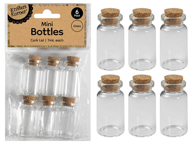set of 6 small clear glass bottles; natural cork lids; cylindrical shape; bottles approx 4cm tall;