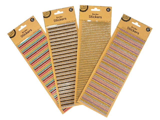 Rhinestone border stickers on brown card backing; Assorted colours including silver, pink, blue, black; Strips of small, round rhinestone stickers; Rows of stickers arranged uniformly in straight lines;