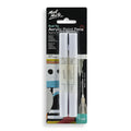 Two white dual tip paint pens in blister pack; Black folded backing card with branding; Packaging shows fine and broad tip illustrations; Colour indicated as white on packaging;