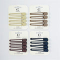 Each pack contains four matching duck-style hair clips; Clips have a hollow teardrop or drip-shaped design; Matte finish in neutral tones such as beige, brown and navy; Mounted on white backing cards branded "Connice" with hang tab;