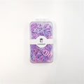 Clear rectangular plastic case with lid; Mix of small pastel purple, pink and blue elastics; White paper band label with brand name “CONNICE”; Circular logo with crown icon on the label;