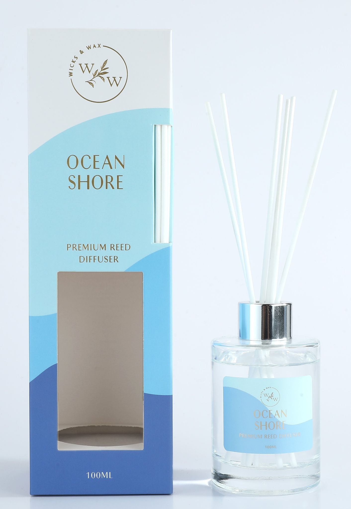 clear glass diffuser bottle; white reeds included; blue and white box packaging; silver-coloured diffuser collar;