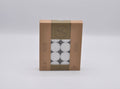 20 white tealight candles; packaged in a brown cardboard box with clear window; 9 hours burn time labelled on box; lead-free and smokeless icons visible; brand name Wicks & Wax;