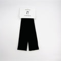 Two black fabric headbands on a hang-sell card; Headbands appear wide and flat; Plain solid black colour; White branded card with cut-out hanger;