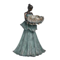 Figurine of a woman holding a large flower-shaped bowl; Bell-shaped, flowing dress with textured vertical lines; Aged bronze look on skin and bowl edges; Green patina-style finish on dress; Hair styled in a neat bun;