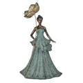 Figurine of a lady in a long flowing strapless gown; Distressed green patina-style finish on dress; Bronze-toned skin and hair in a bun; Tall metal flower stem with large peony bloom;