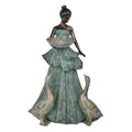 Tall figurine of a lady in a long, layered gown; Lady holds a textured bowl at waist height; Two geese stand at the base on either side; Finish appears in aged green with bronze highlights;