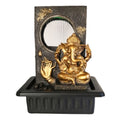 Gold-toned Ganesh statue seated at the front; Black stone-look rectangular backdrop with carved details; Water curtain feature within a circular window; Black rectangular basin-style base; Contrasting gold hand motif on the left side of the backdrop;