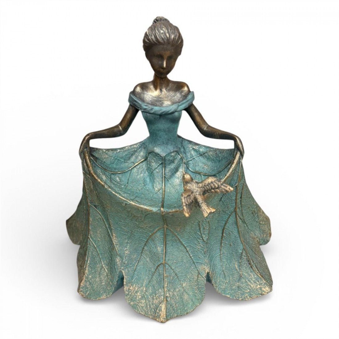 Bronze-toned girl figurine with stylised features; Large teal dress shaped like overlapping leaves; Small bird resting on the front of the skirt; Matte, textured finish with gold highlights;