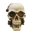 Bone-coloured skull-shaped ornament; Detailed eye sockets, teeth and facial features; Red roses and green vines around the skull; Resin material with aged, antique-style finish;