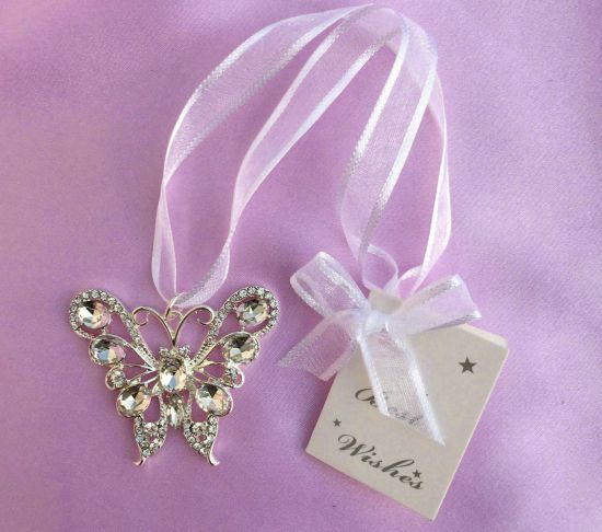 silver-tone butterfly shape; clear rhinestones embedded; sheer white hanging ribbon; white gift tag with bow attached;