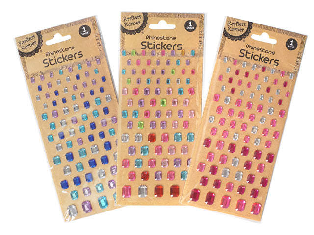 emerald green rhinestones; various sizes; self-adhesive stickers on sheet; clear backing visible; packaged on cardboard backing;
