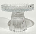 clear glass material; ribbed texture on surface; round top surface; short pedestal base; compact size;