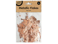 Rose gold colour flakes; Transparent plastic packaging; Brown kraft paper label; Brand name: Krafters Korner; 2g weight marked on label;