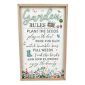 Rectangular wooden-framed wall sign; White background with pastel garden illustrations; Text reads various "Garden Rules" phrases; Floral border along bottom edge; Images of boots, birds, butterflies and plants;