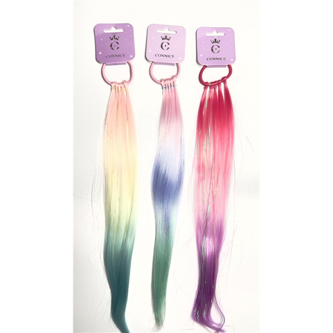 Long straight synthetic hair strands; Ombre pastel and bright rainbow colours; Fine iridescent tinsel-like strands mixed in; Hair attached to a coloured plastic ring; Packaged on a small purple backing card with crown logo;