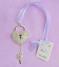 heart-shaped lock; silver colour; diamante embellishments; attached pale purple ribbon; heart-shaped key charm;