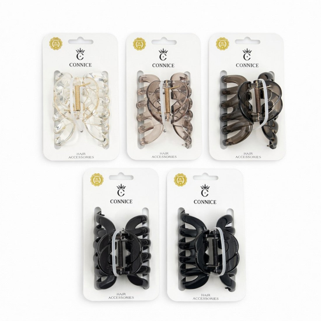 Medium-sized plastic claw clips; Neutral colours including clear, brown and black; Metal spring closure mechanism; Each clip displayed on white branded card packaging;