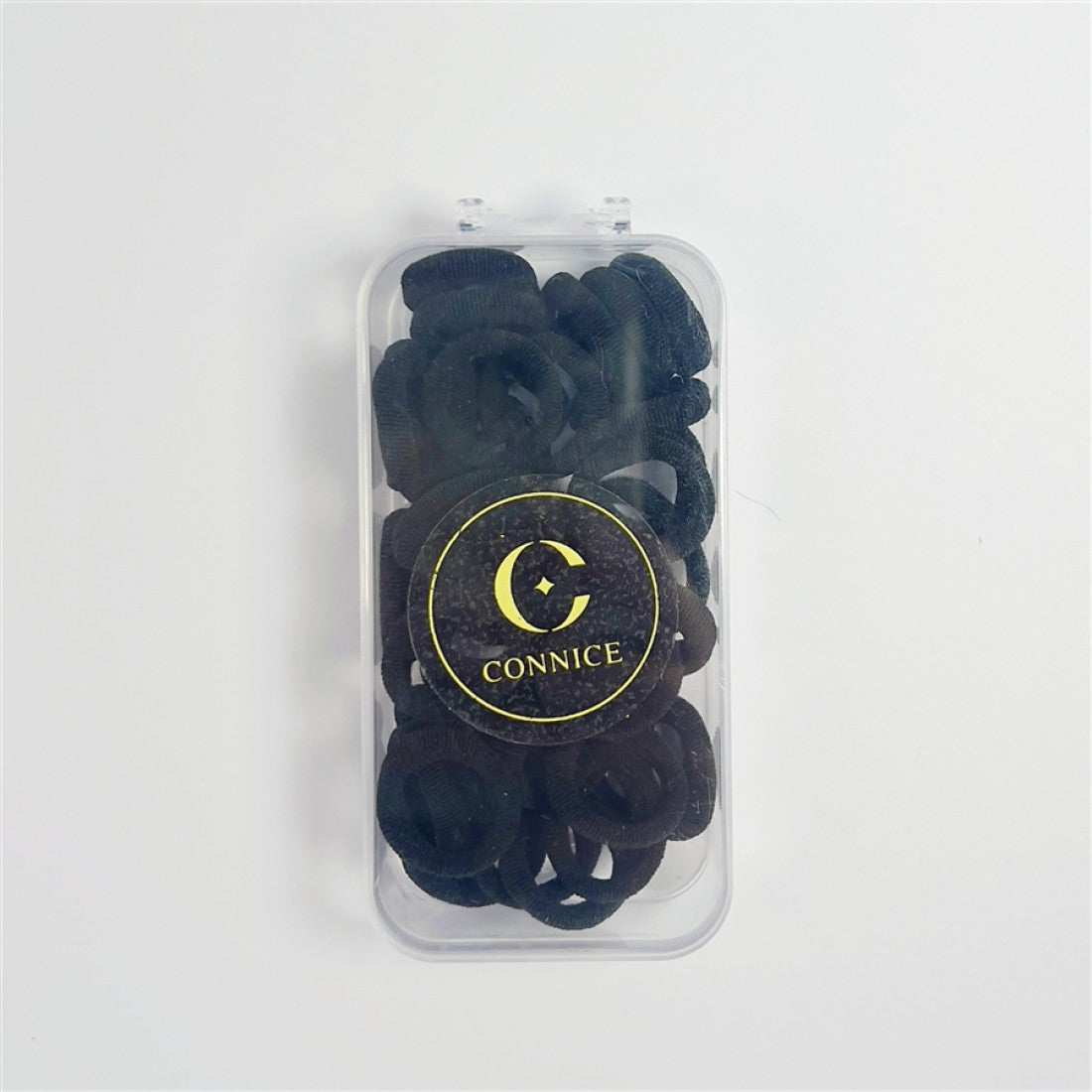 Black fabric-covered elastic hair ties; Compact circular hair tie shape; Clear rectangular plastic case; Gold and black round Connice logo on the case;
