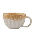 Ceramic material; Nougat colour with speckled pattern; Textured finish; Rounded handle; Wide cup shape;