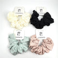 Large, gathered fabric scrunchie; Textured fabric with subtle linear pattern; Shown in soft muted colours including cream, black, mint and blush; Each scrunchie displayed on white branded backing card;