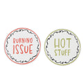 set of two round ceramic trivets; white base colour with black decorative border; one trivet with red text 'BURNING ISSUE'; one trivet with green text 'HOT STUFF'; each trivet approx. 20cm diameter;