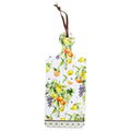 rectangular trivet shape with handle; white ceramic surface with colourful fruit print; includes brown hanging ribbon; bottom edge has patterned trim; ceramic-cork material blend;