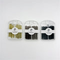 Three clear plastic cases shown side by side; Hair pins in gold, brown and black tones; Compact rectangular cases with rounded tops and hanging hole; White CONNICE branded bands wrapped around each case;