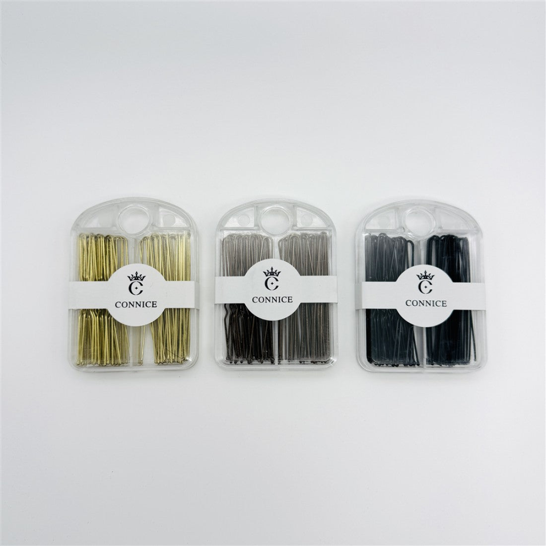 Pins supplied in a clear plastic case; Three colour options shown: gold, silver and black; Front band on case printed with brand name "CONNICE"; U-shape metal pins neatly stacked inside the case;