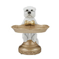 white West Highland Terrier dog figure; gold bow tie on the dog; gold decorative tray held by dog; ornate gold base with texturing; resin material with detailed sculpting;