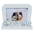 white rectangular frame; holds 6x4 inch photo; attached decorative 'Mr & Mrs' script; sturdy base stand; smooth finish;