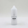 white cylindrical candle; approx 5cm diameter and 15cm height; smooth surface with printed label; tapered top with wick; plain white colour;