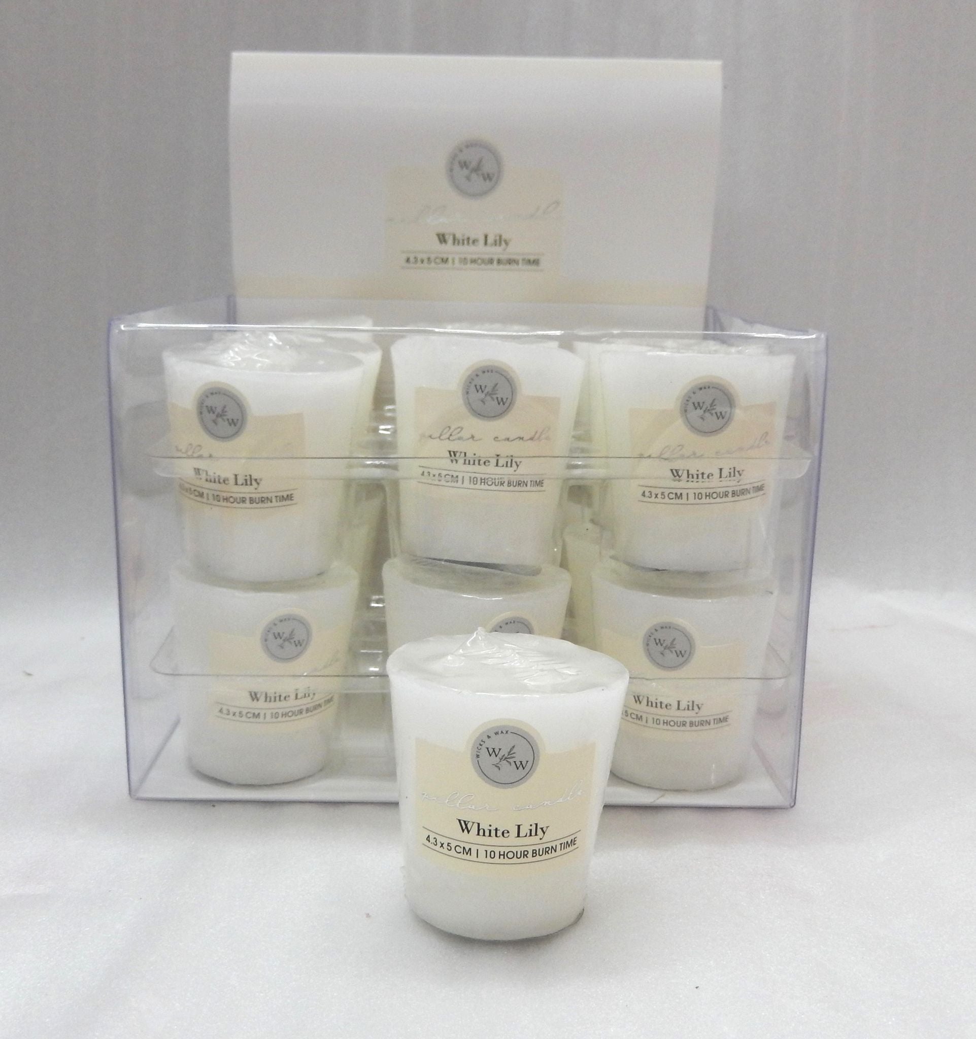 white candle in transparent plastic container; label with white lily scent; pack of 9 candles in clear plastic box; cylindrical votive candle shape;
