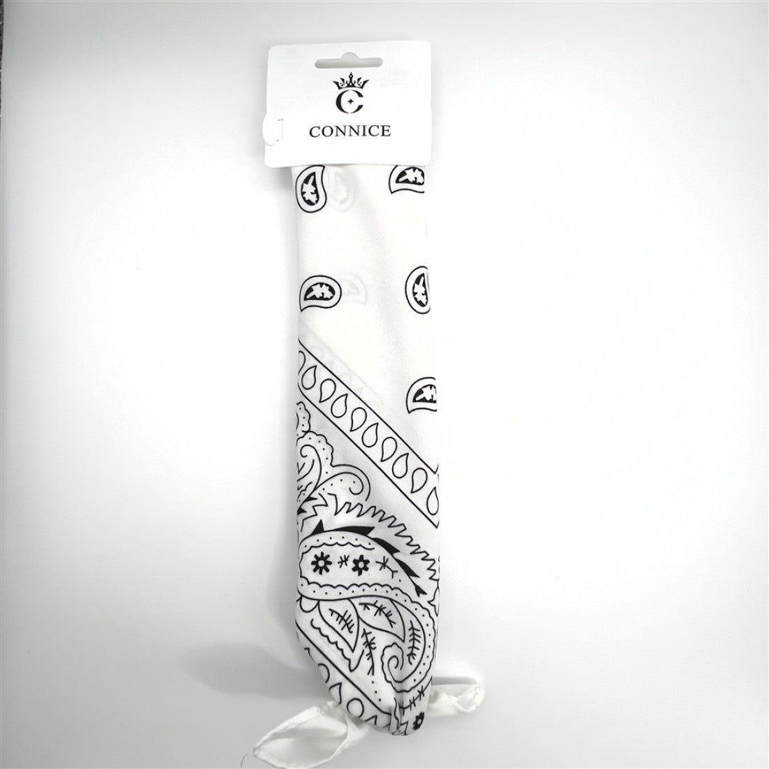 White fabric bandana; Black paisley and patterned print; Rectangular folded presentation; Hanging on white branded card packaging;