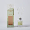 clear glass diffuser bottle; silver-coloured neck ring; white reed sticks; green and white box with clear window; lemongrass and lime label;