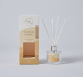 Clear round glass bottle with silver collar; White reed sticks inserted in diffuser; Beige and cream coloured packaging; Label on bottle matching packaging colour; Diffuser liquid visible inside bottle;