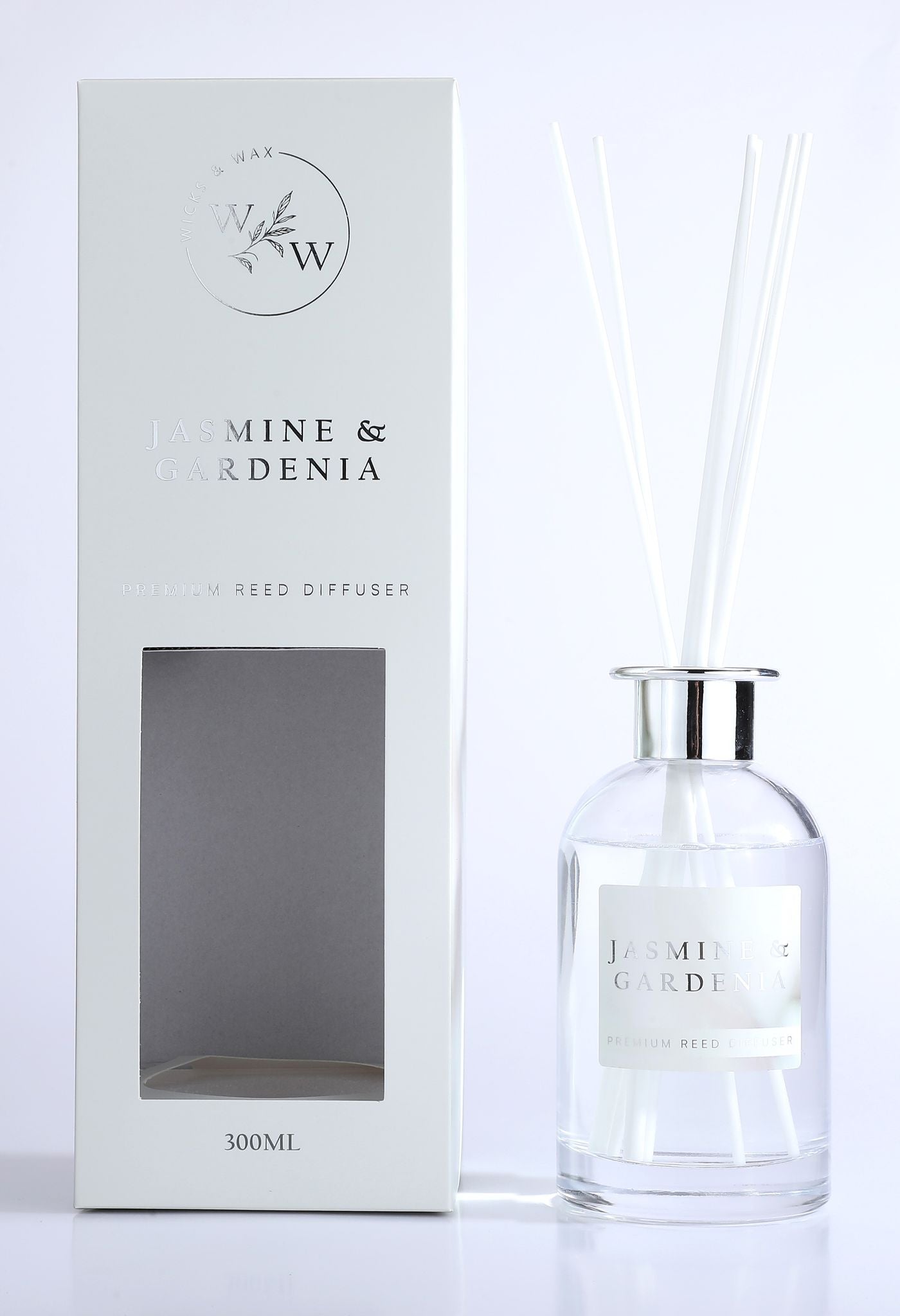 clear round glass bottle; metallic silver collar; white diffuser reeds; white box packaging with silver embossed text;