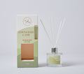 Clear glass bottle with light green label; Five white reed sticks inserted into bottle; Box packaging with gradient green and cream colours; Label and box text in gold colour;