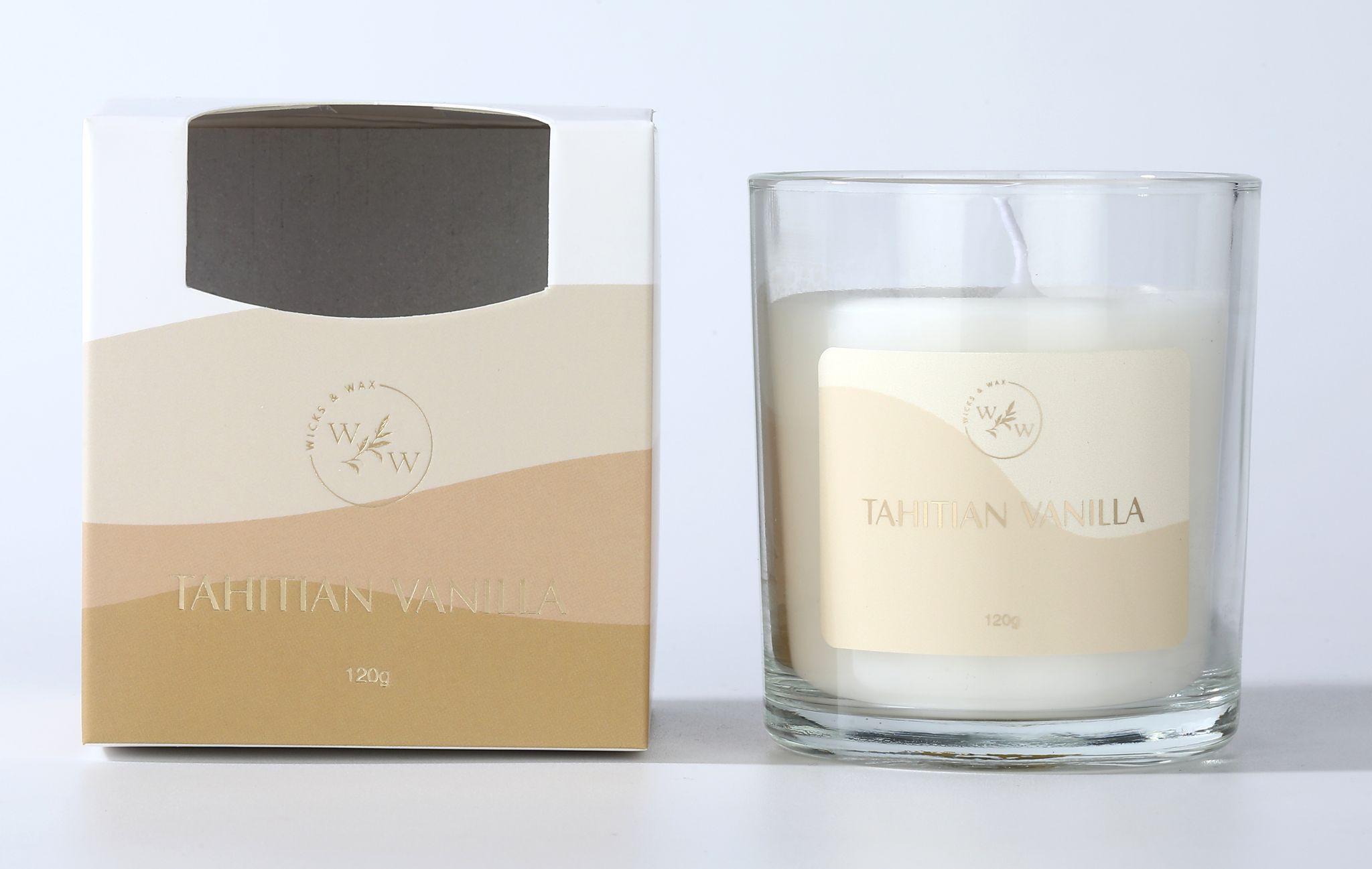 clear glass container; cream coloured wax; label with beige and light brown wavy design; gold embossed text on label; white wick;