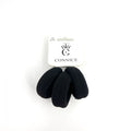 Three thick black elastic hair bands; Ribbed terry-style fabric texture; Mounted on white branded card labelled "Connice"; Simple, minimal black and white packaging;