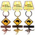 metal keyring with circular ring; yellow diamond-shaped roadsign with black Australia map; wiggling kangaroo charm attached below roadsign; available in copper, gold and silver finishes; packaged on yellow card with red and blue border;