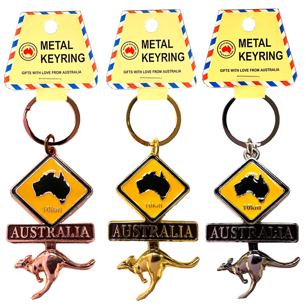 metal keyring with circular ring; yellow diamond-shaped roadsign with black Australia map; wiggling kangaroo charm attached below roadsign; available in copper, gold and silver finishes; packaged on yellow card with red and blue border;