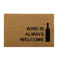 natural light brown coir material; black text 'WINE IS ALWAYS WELCOME'; black wine bottle silhouette; rectangular shape; PVC grey backing visible on reverse side (from image);